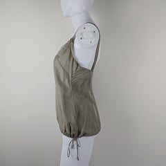 Grey top on a white mannequin against a plain background