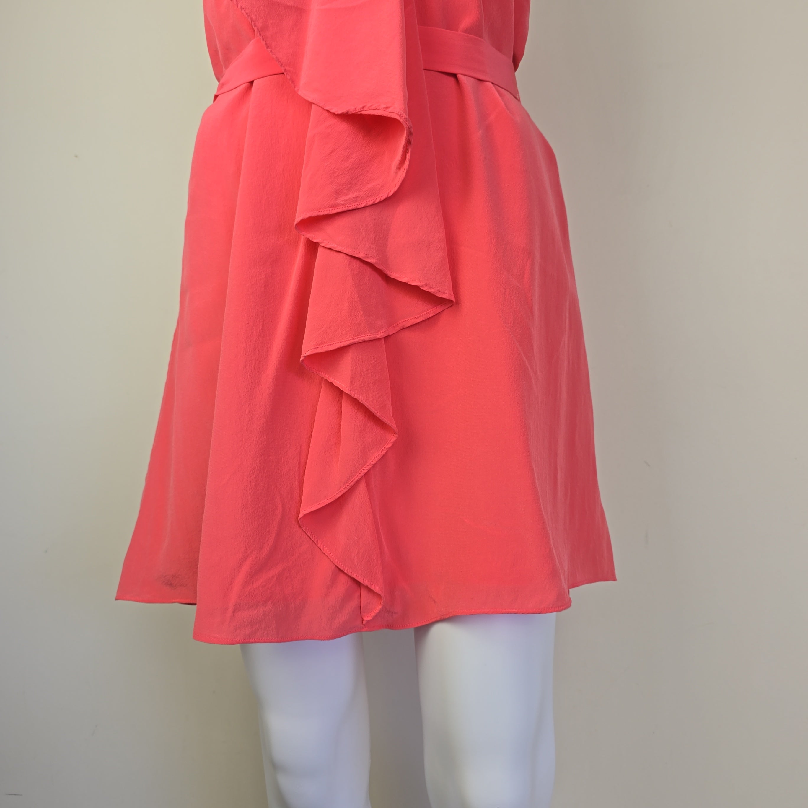 Pink dress with ruffled details on a light background