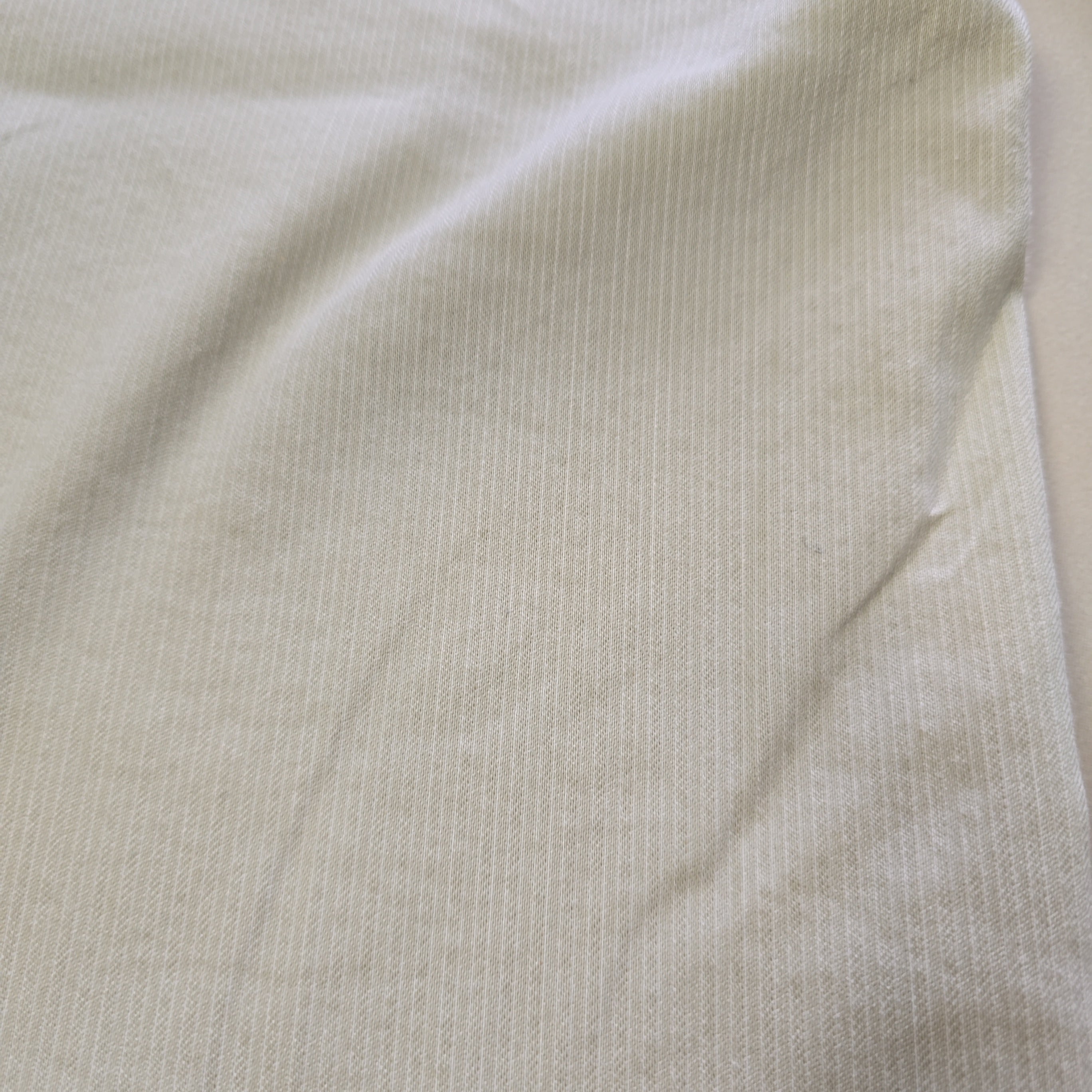 Close-up of beige fabric with a subtle pattern