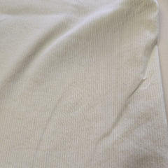Close-up of beige fabric with a subtle pattern