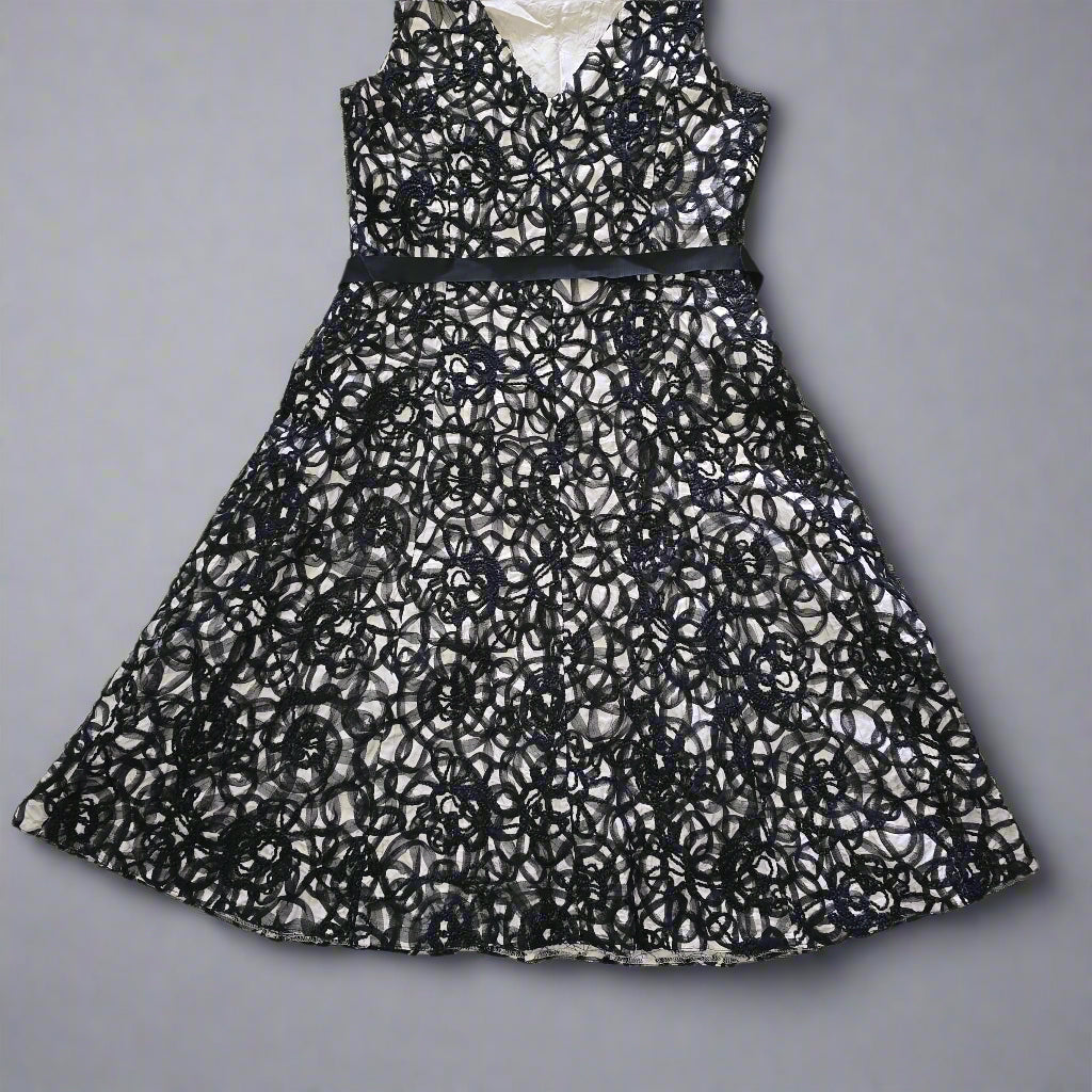 Black lace dress on a tiled floor