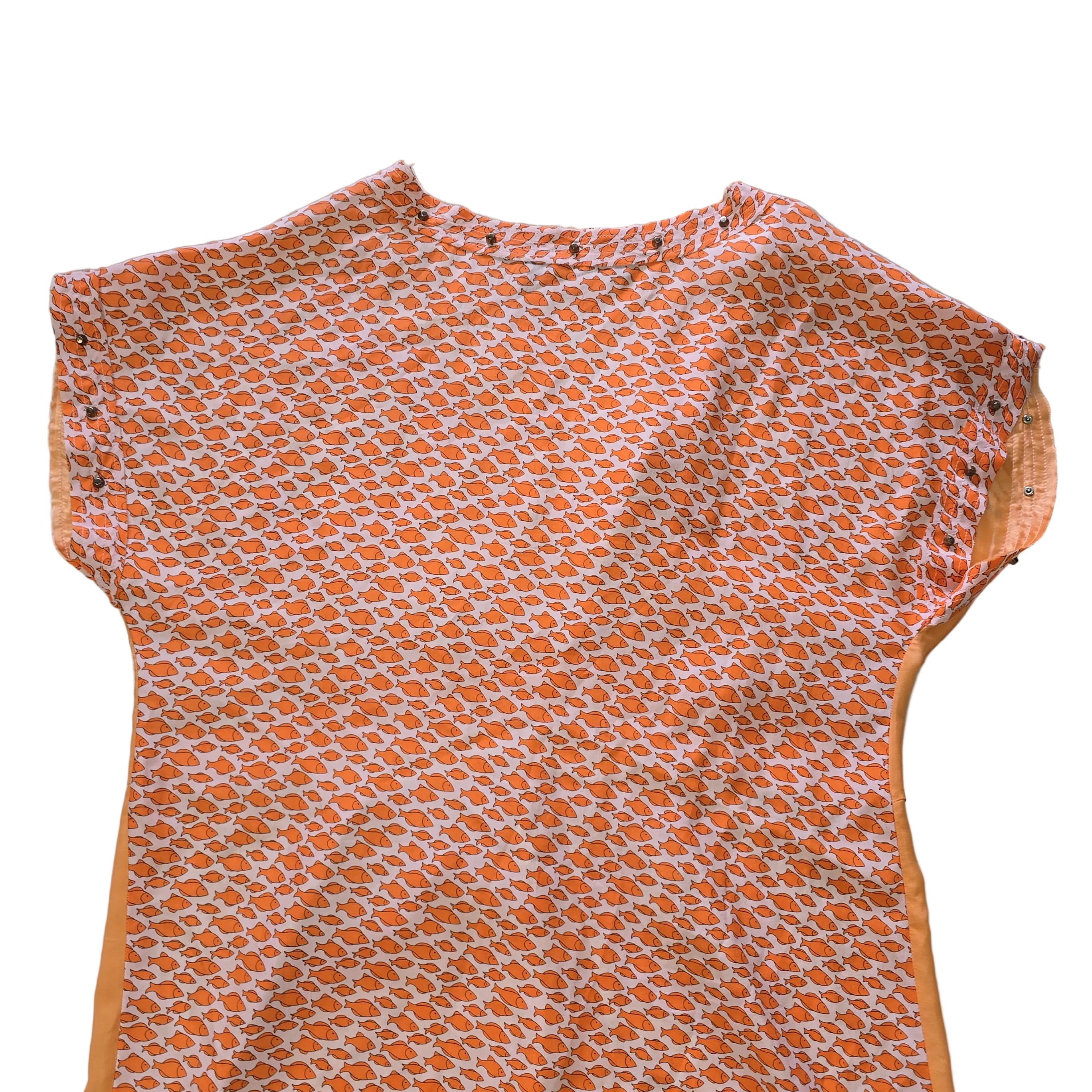 Decorative pink and yellow patterned fabric kaftan on a light background.