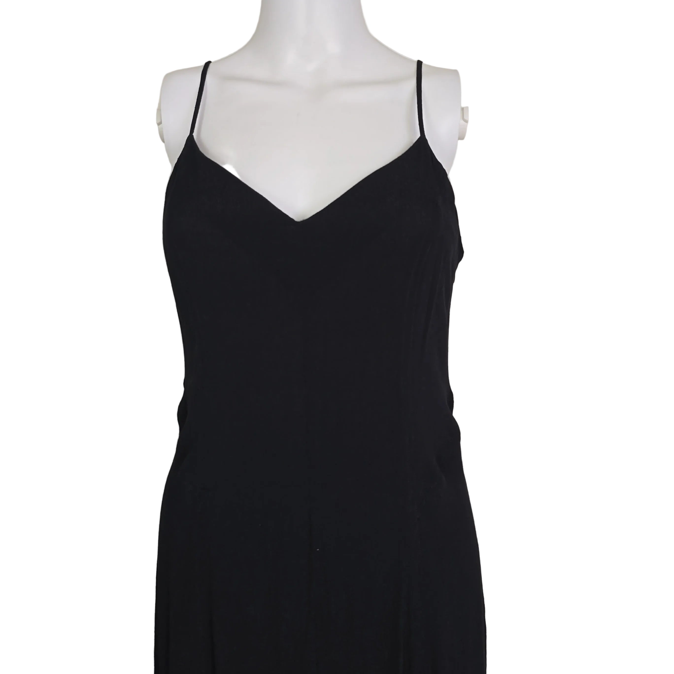Black dress on a white mannequin against a beige background