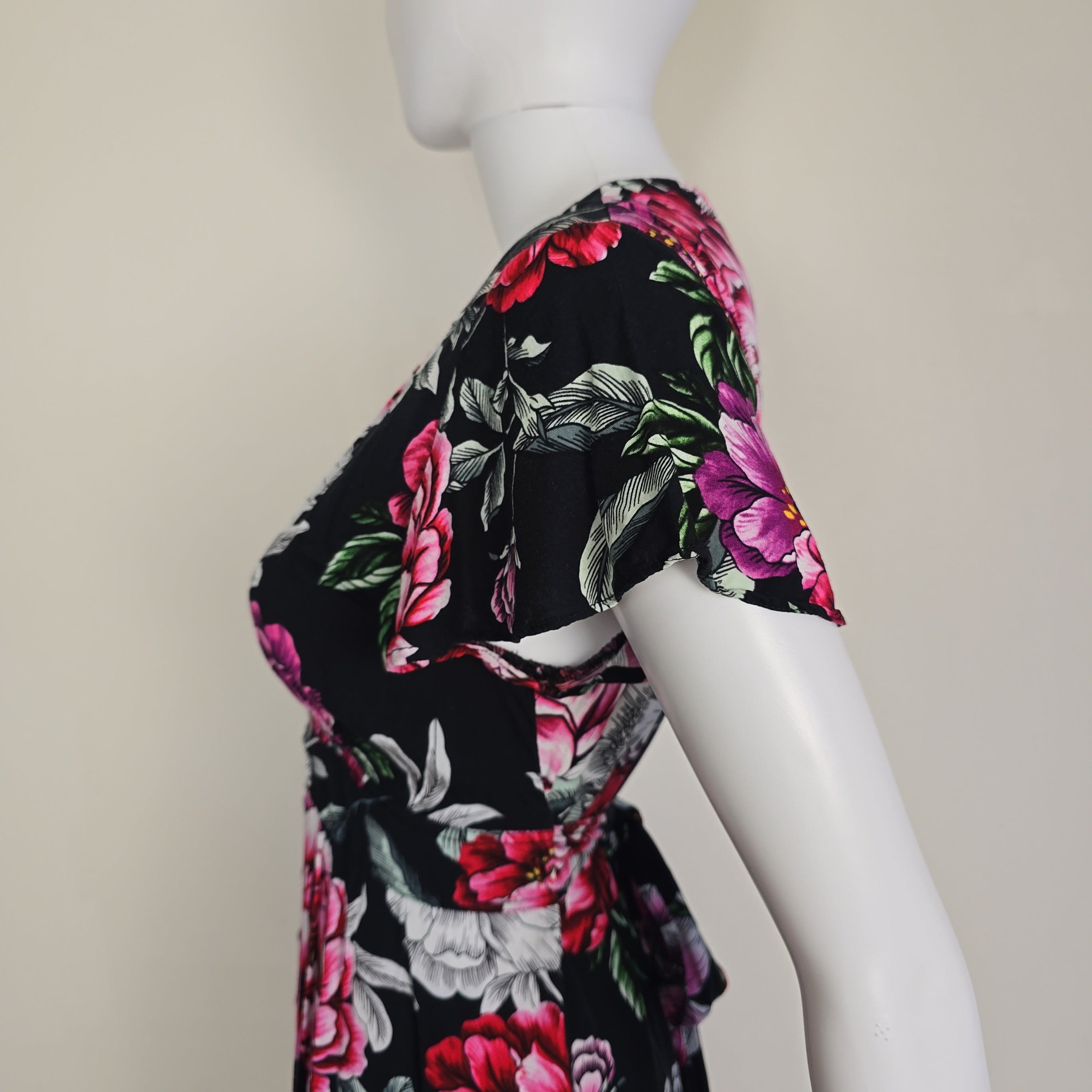 Floral-patterned dress on a mannequin against a neutral background
