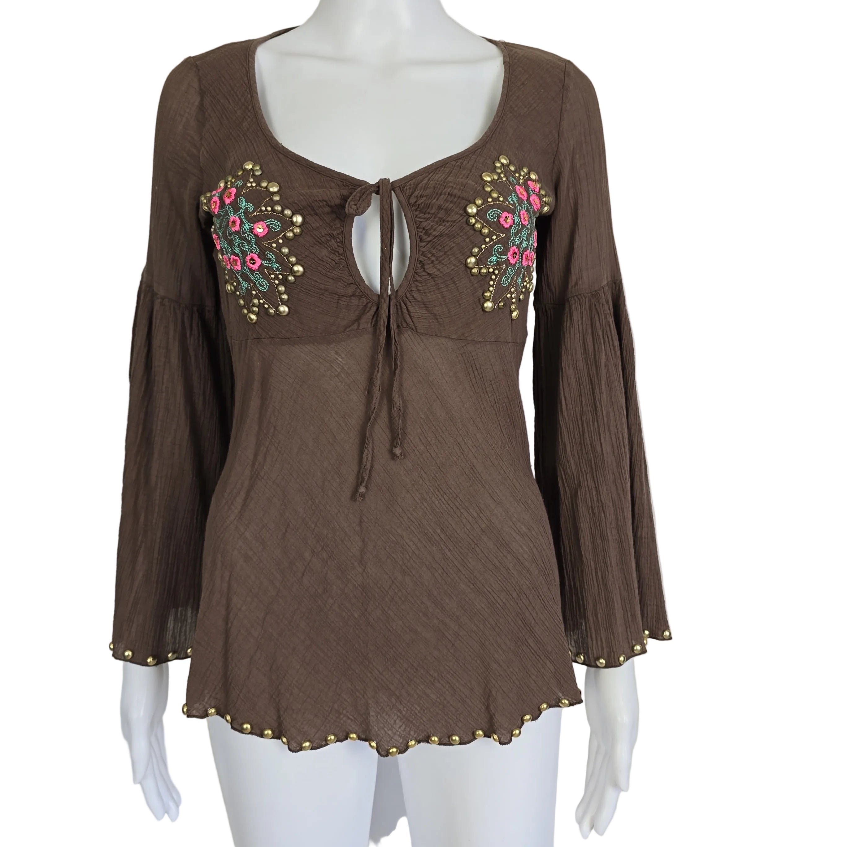 Brown top with floral embroidery on a mannequin against a white background