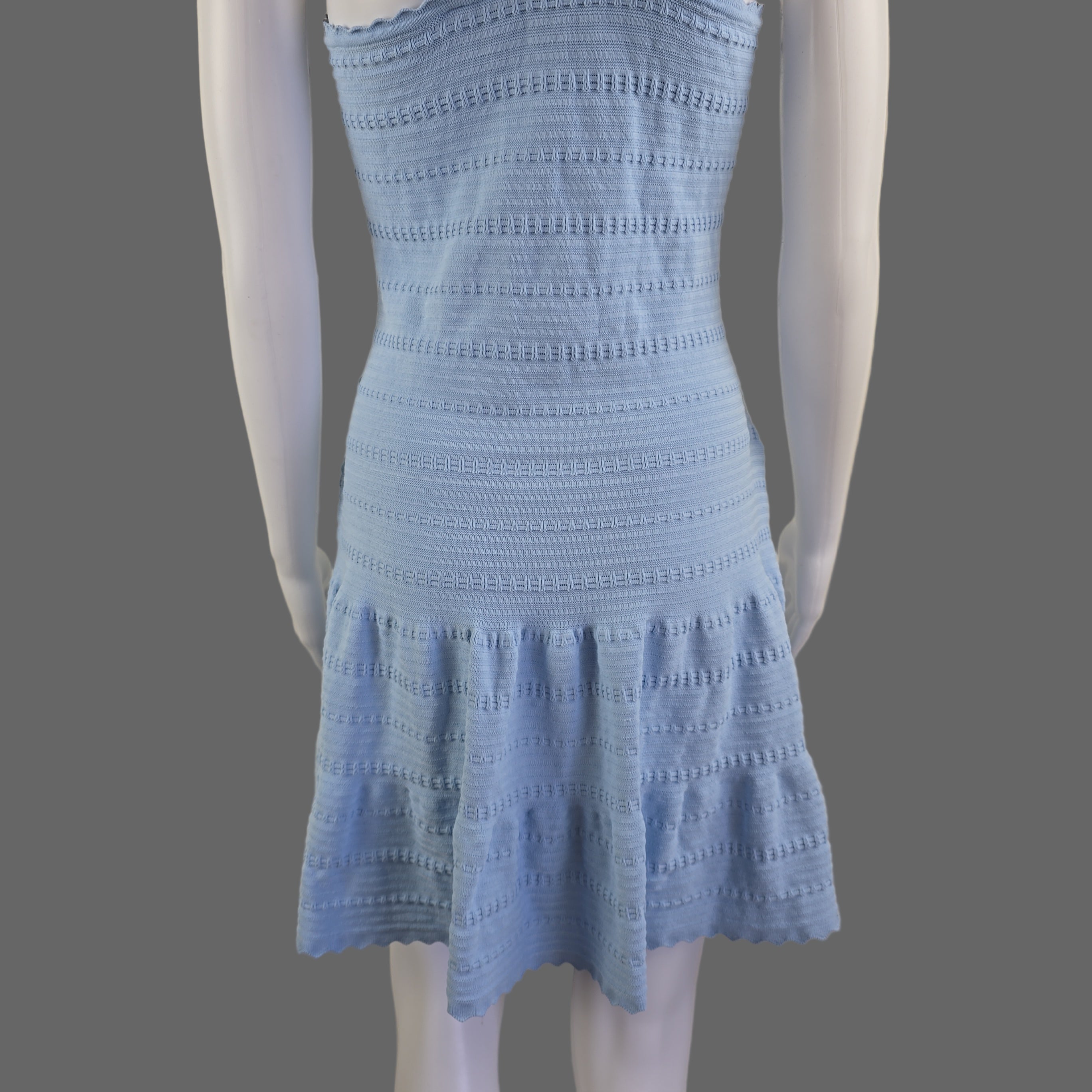 Light blue knitted dress on a white background