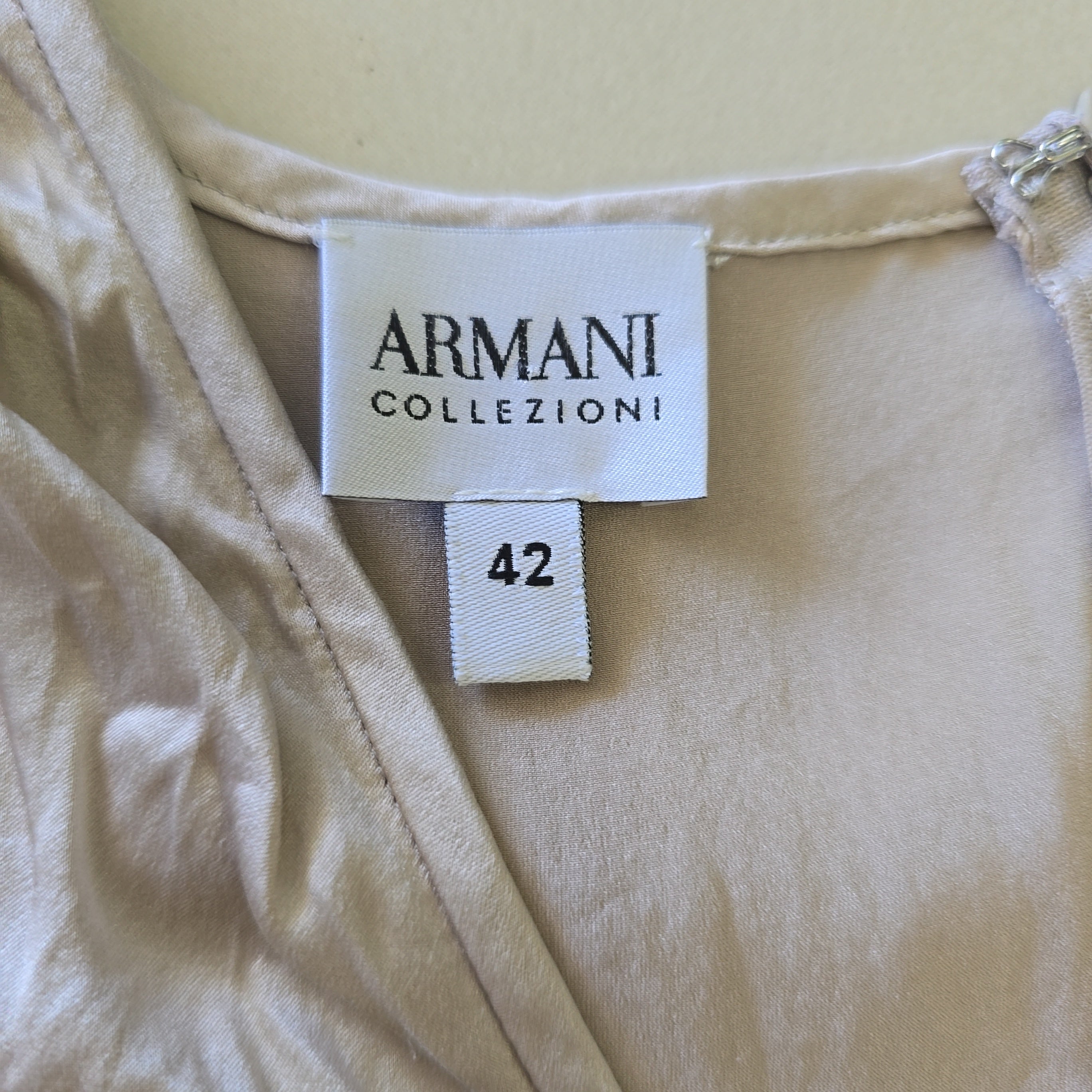 Armani Collezioni label on a beige garment with size 42 tag.