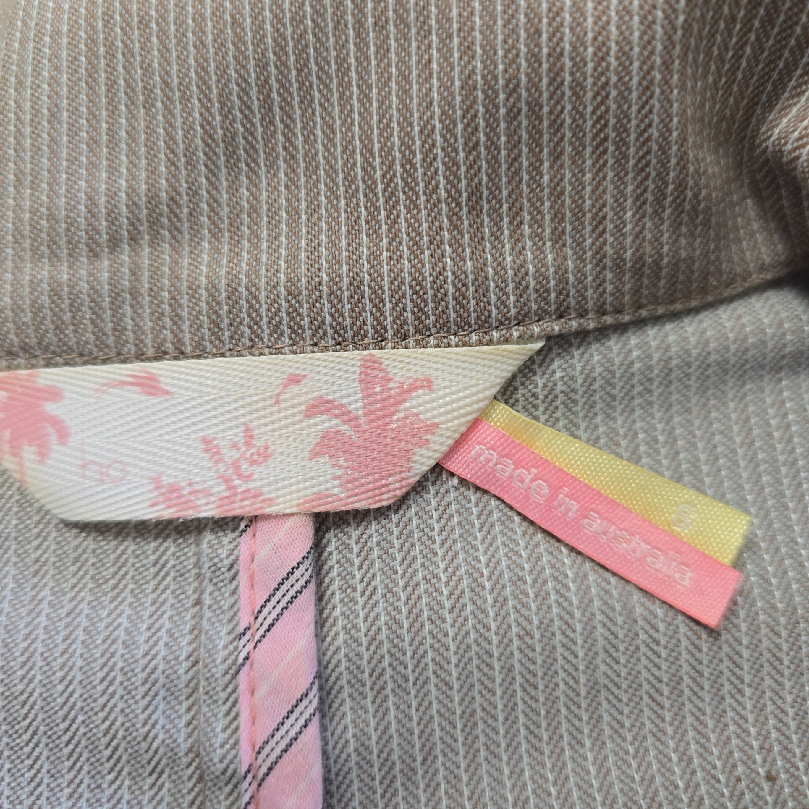 Close-up of a fabric with a floral patterned tag on a textured background