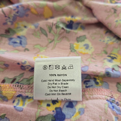 Clothing label on a floral-patterned fabric