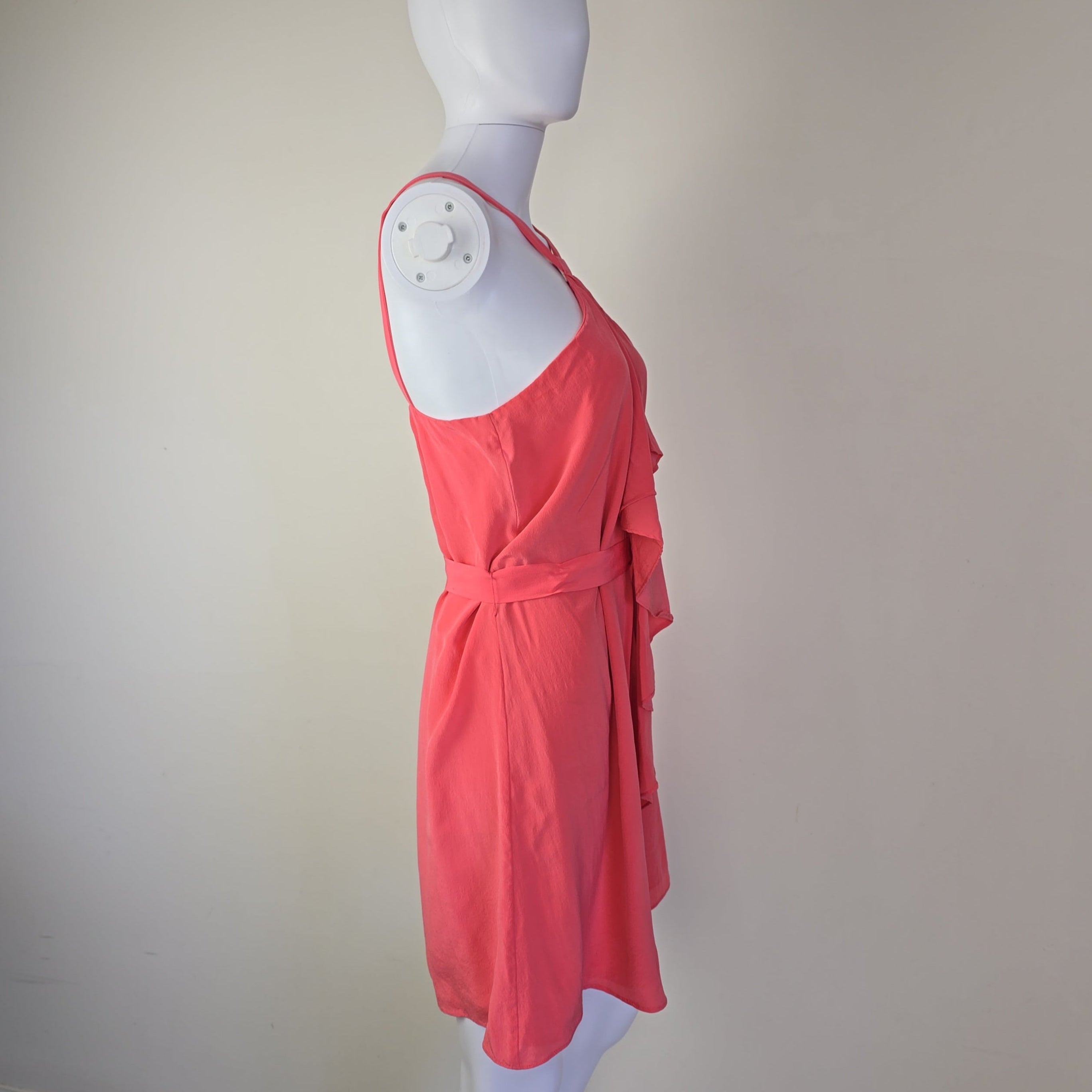 Pink dress on a mannequin against a white background