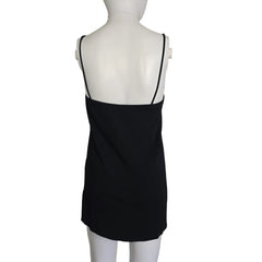 Black dress on a mannequin against a beige background