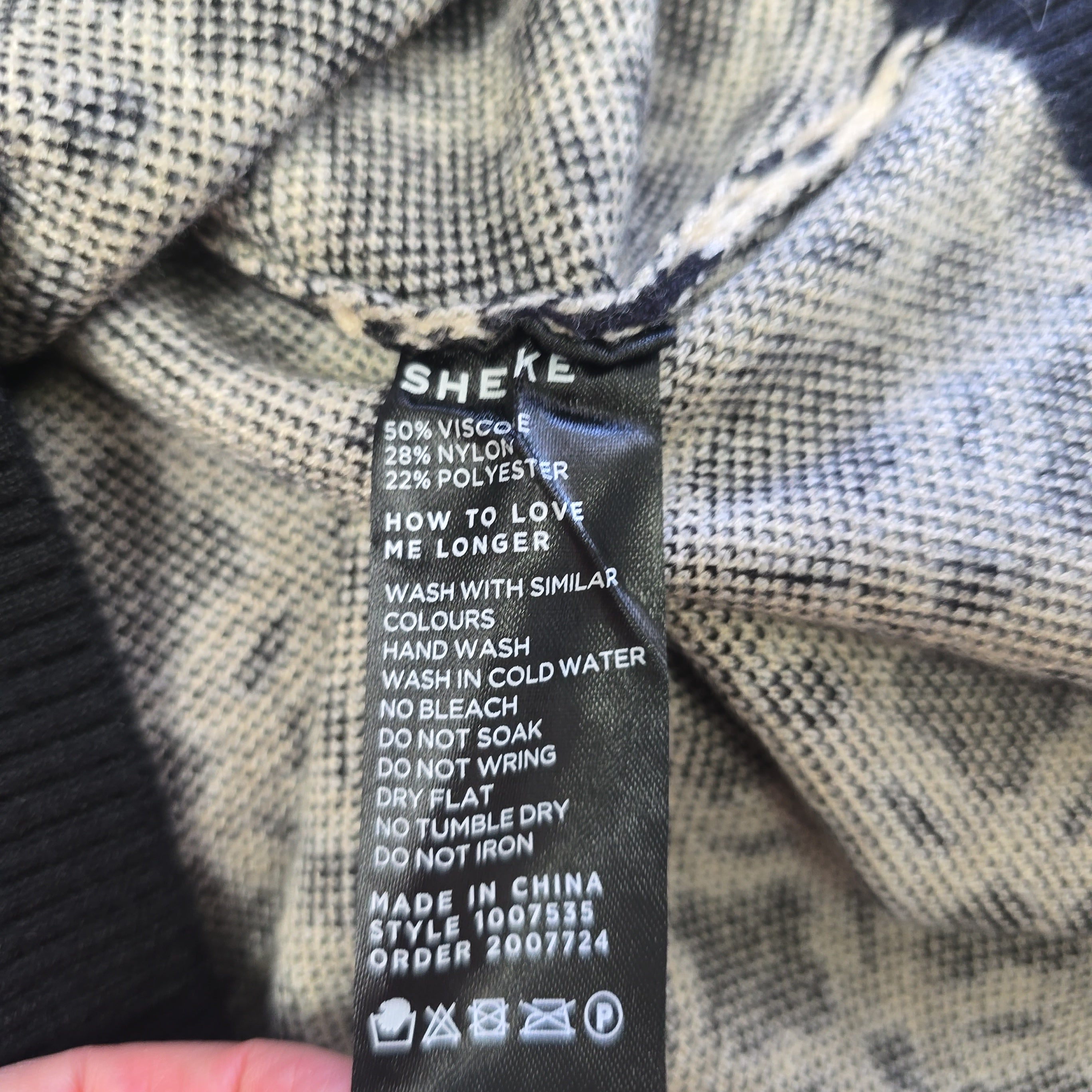 Close-up of a clothing label on a textured fabric background