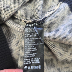 Close-up of a clothing label on a textured fabric background