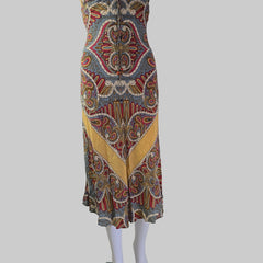 Colorful patterned fabric on a white mannequin arm against a neutral background