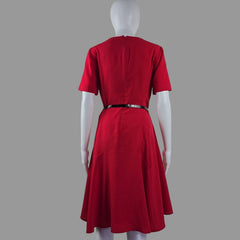 Red dress on a mannequin against a plain background