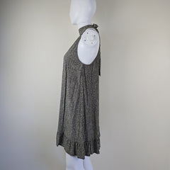 Grey and white spotted patterned dress on a light background