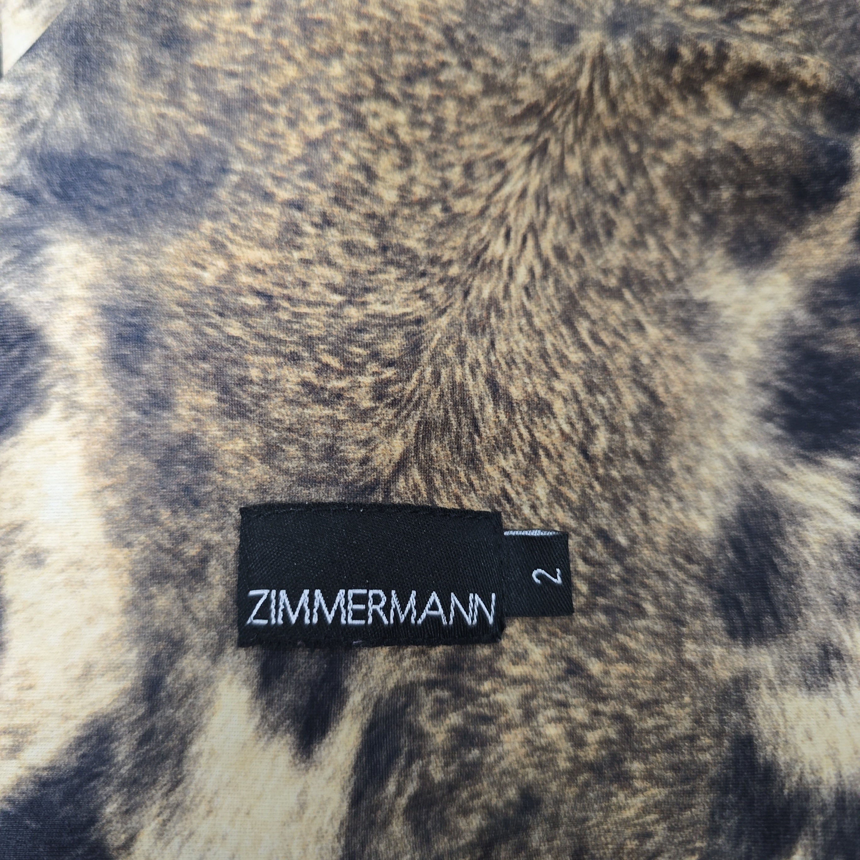 Zimmermann label on a fur printed fabric background