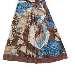 Brown fabric with blue and beige butterfly patterns on a tiled floor