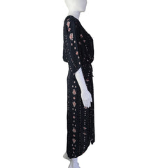 Mannequin wearing a black patterned dress on a light background