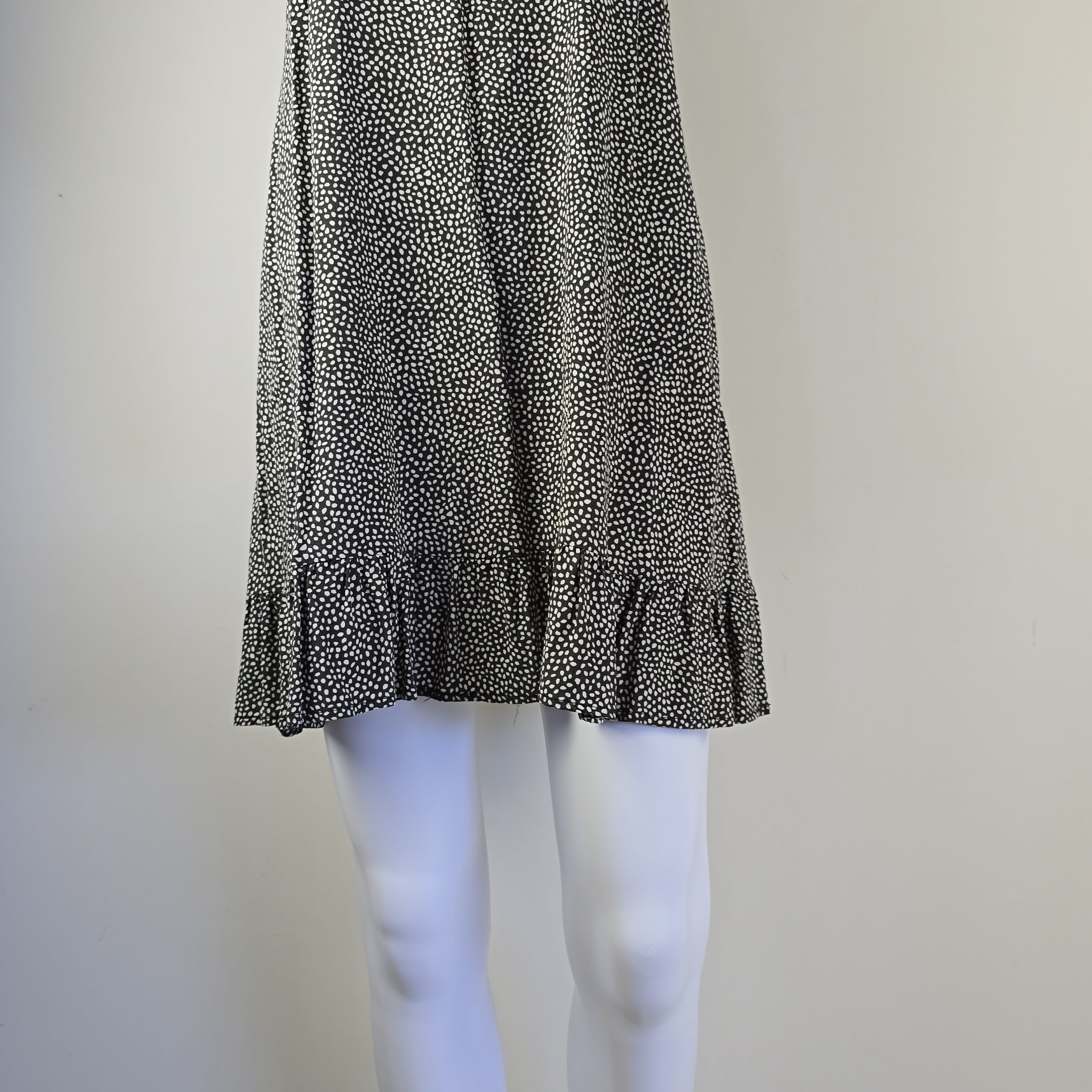 Black and white textured fabric on a mannequin against a neutral background