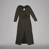 Black and gold textured dress against a light gray background