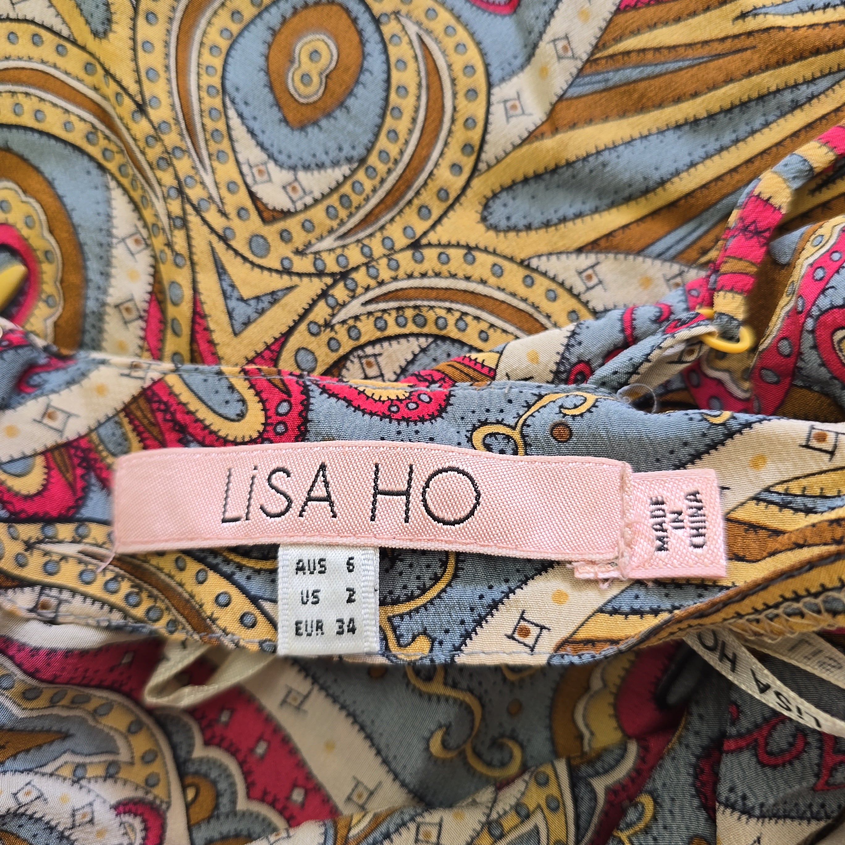 Close-up of a patterned fabric with a visible brand tag labeled 'Lisa Ho'.