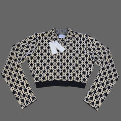 Black and white patterned top on a tiled floor