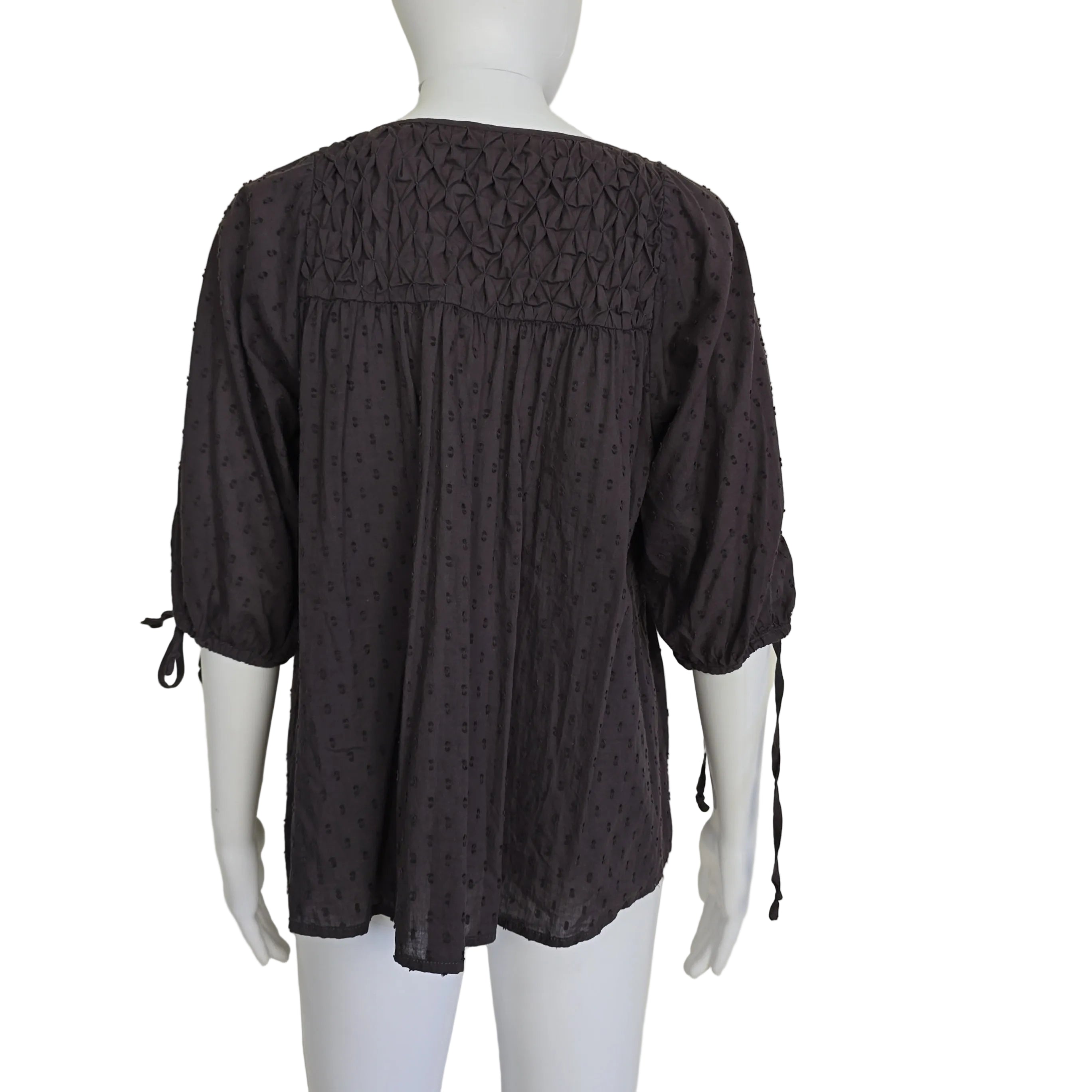 Brown long-sleeve top on a light background