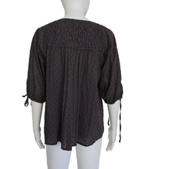 Brown long-sleeve top on a light background