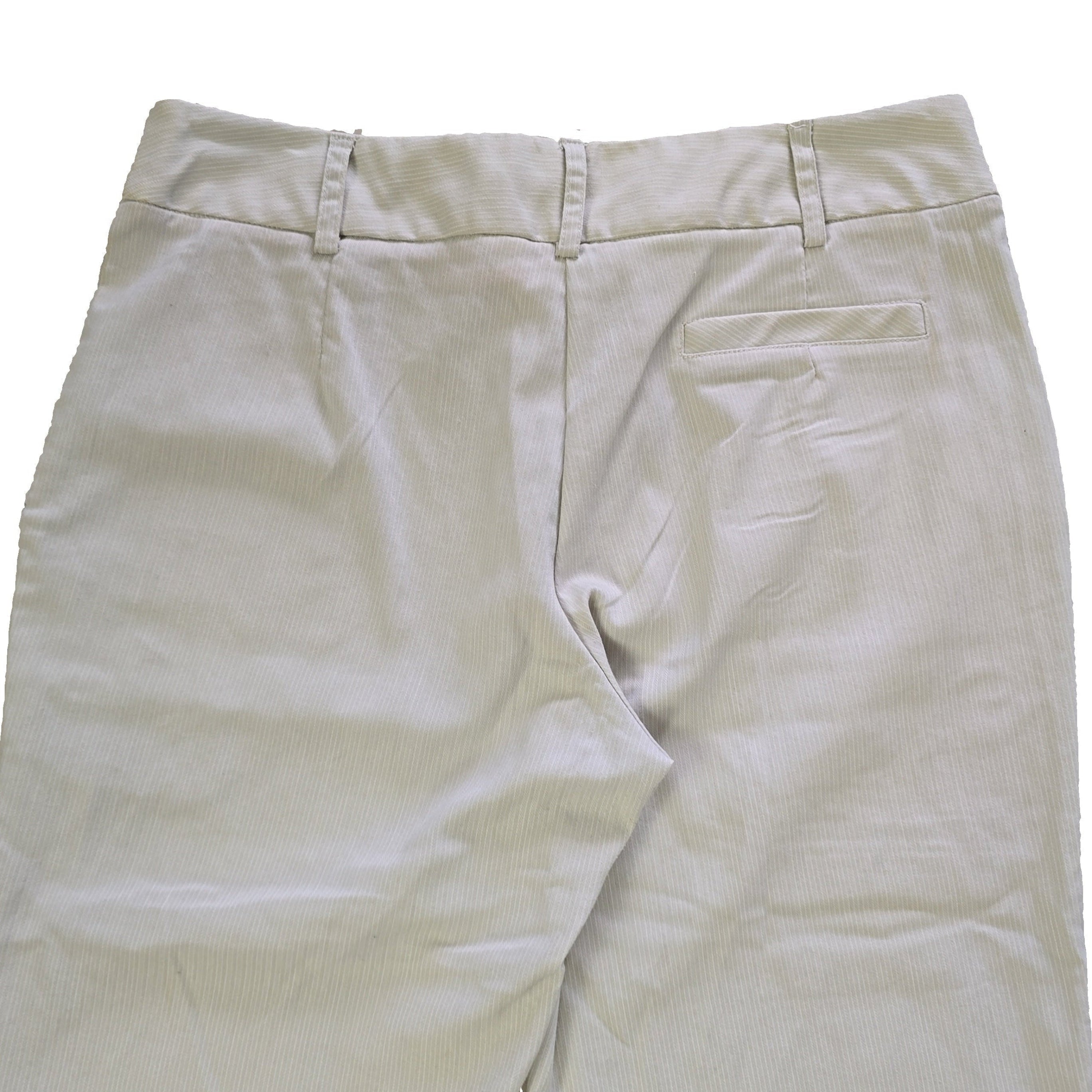 Light-colored pants on a tiled floor