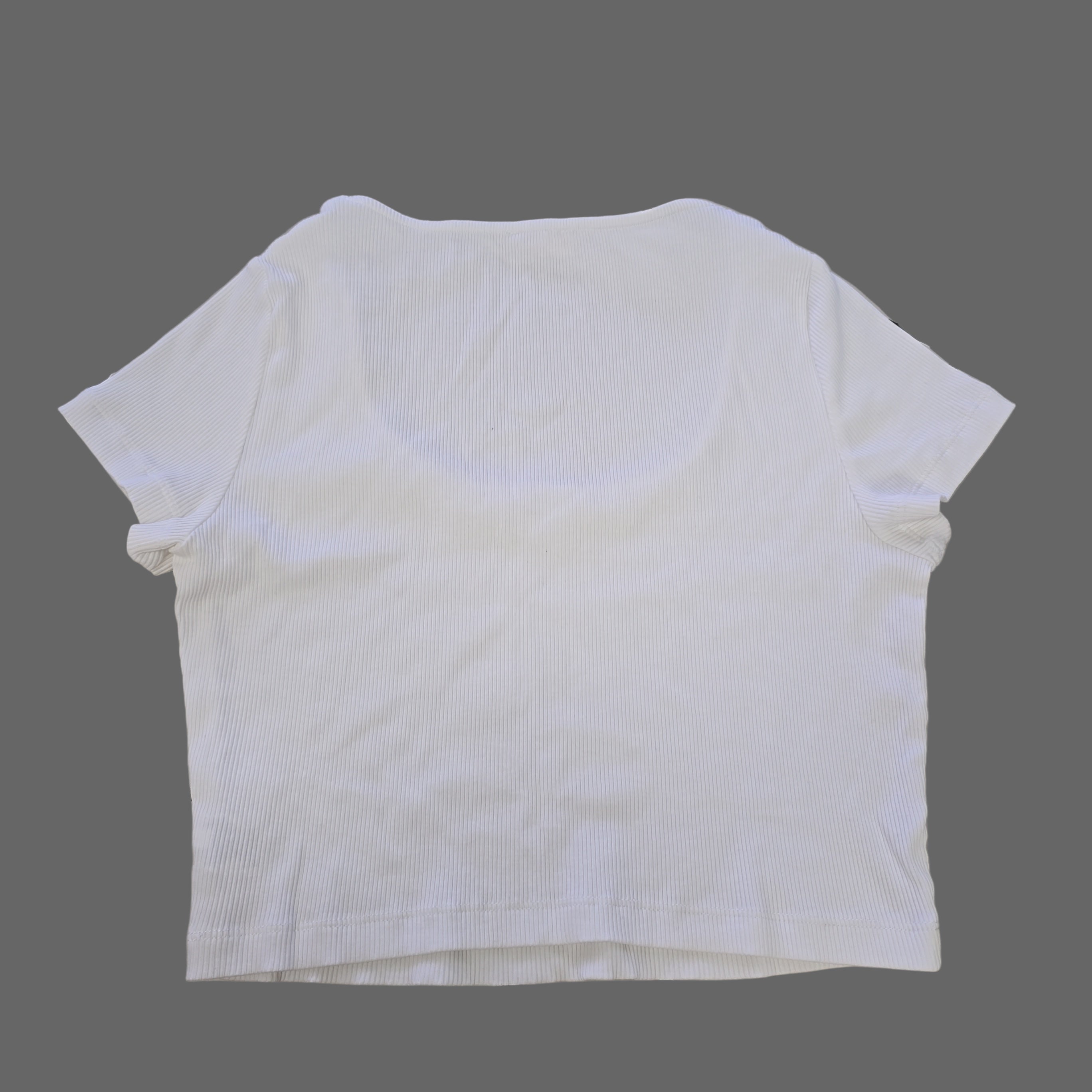 White t-shirt on a tiled floor