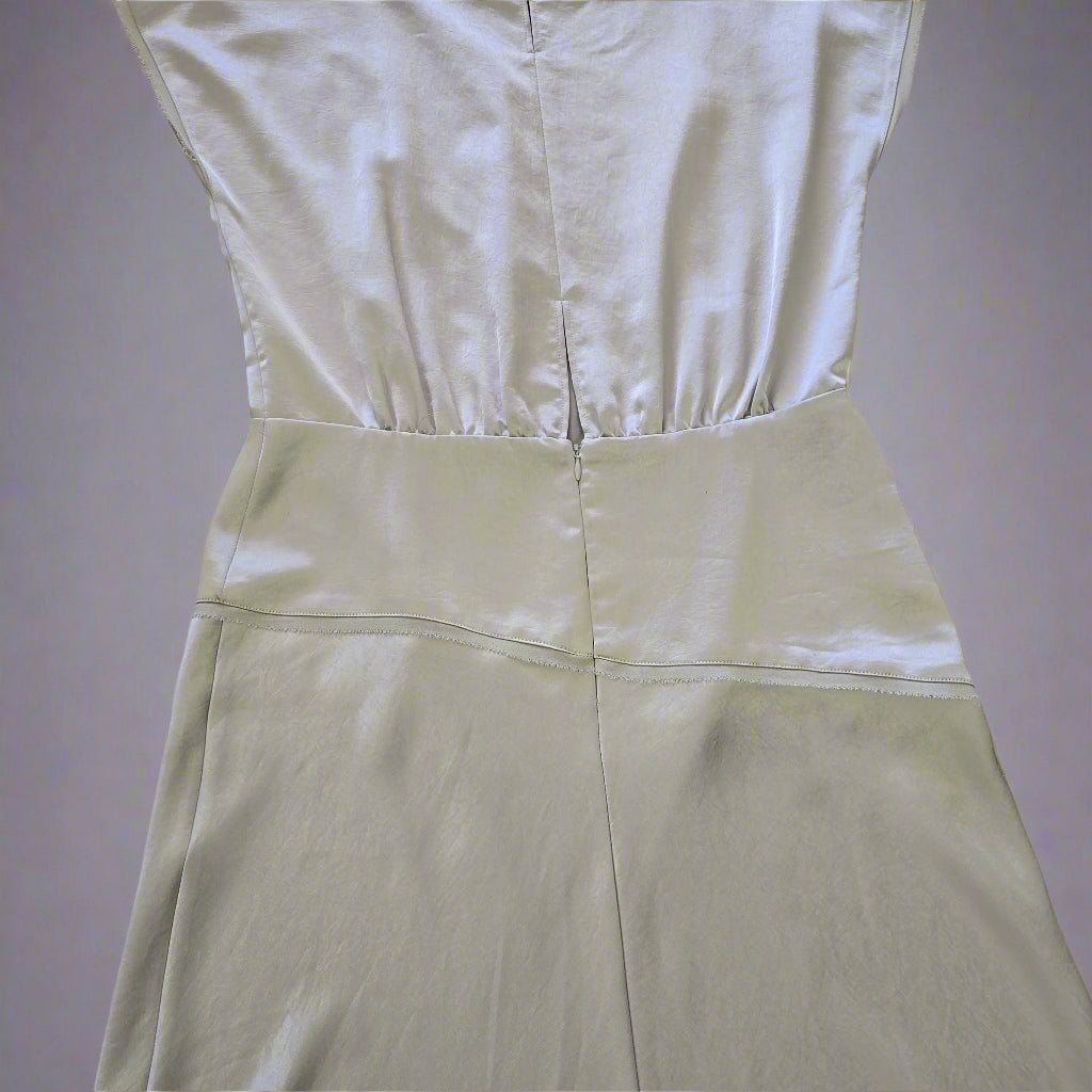 Light green satin fabric on a tiled floor