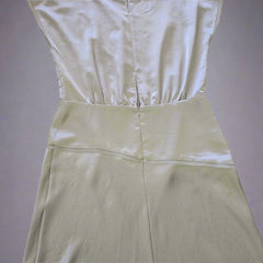 Light green satin fabric on a tiled floor