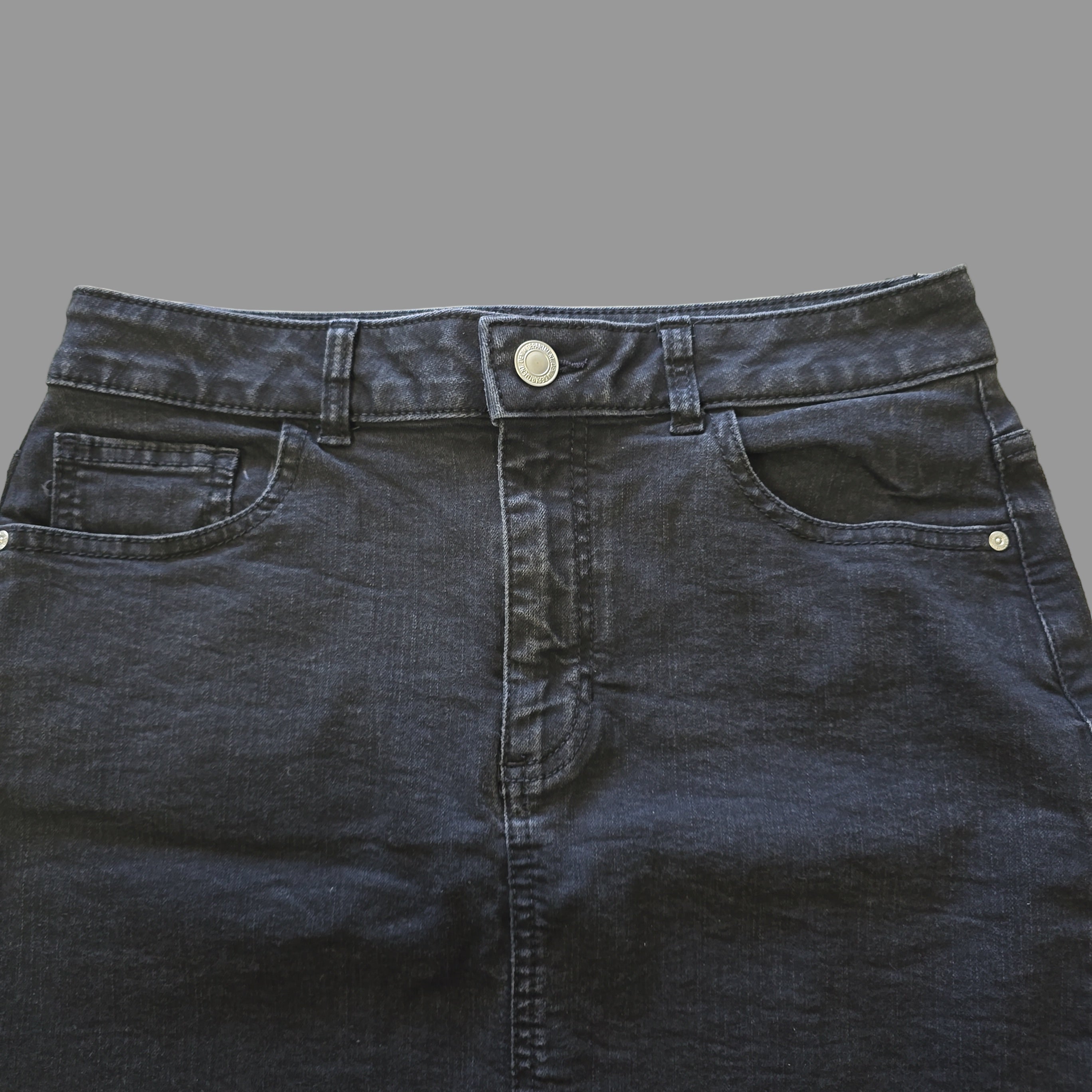 Dark grey denim fabric on a tiled floor