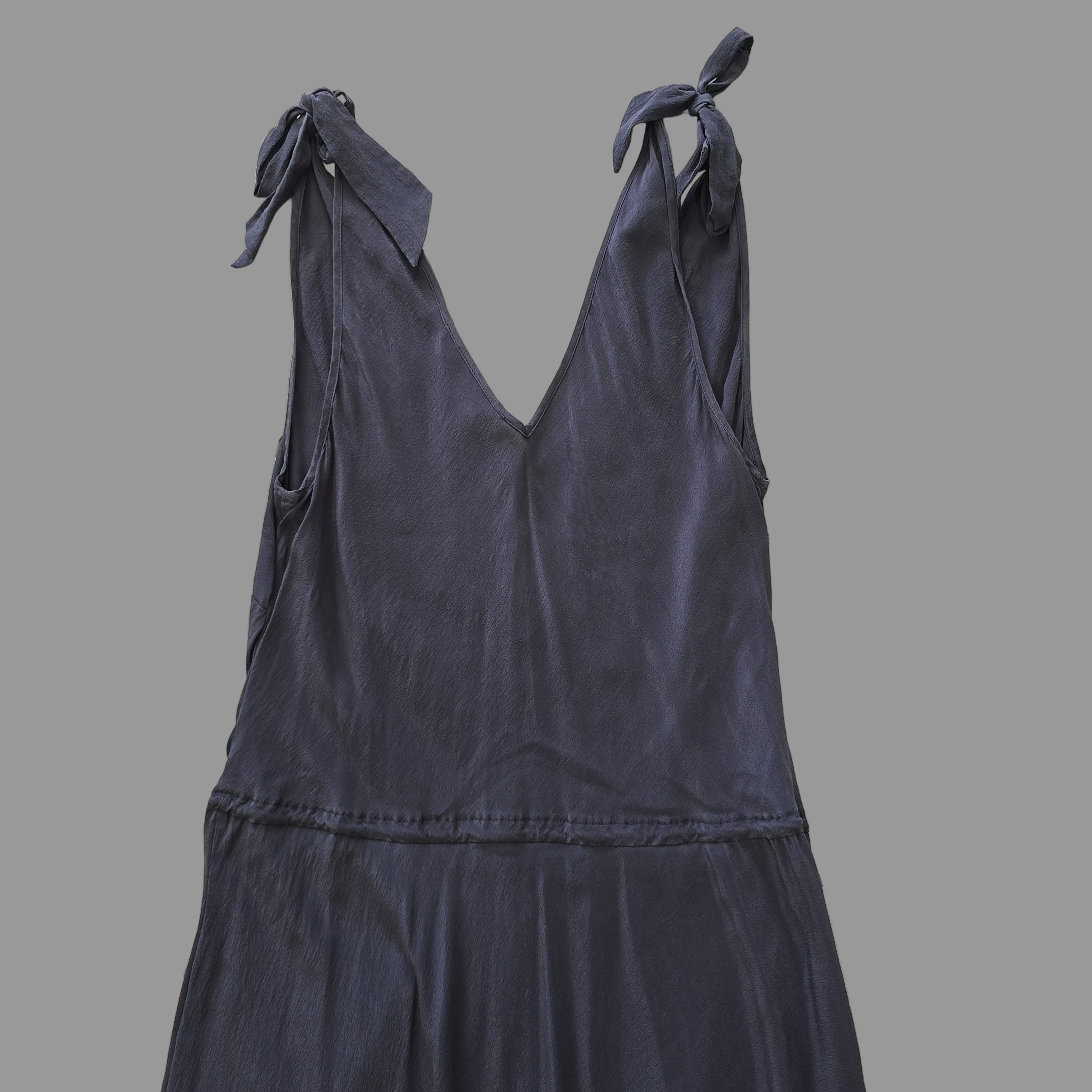 Dark grey dress on a tiled floor