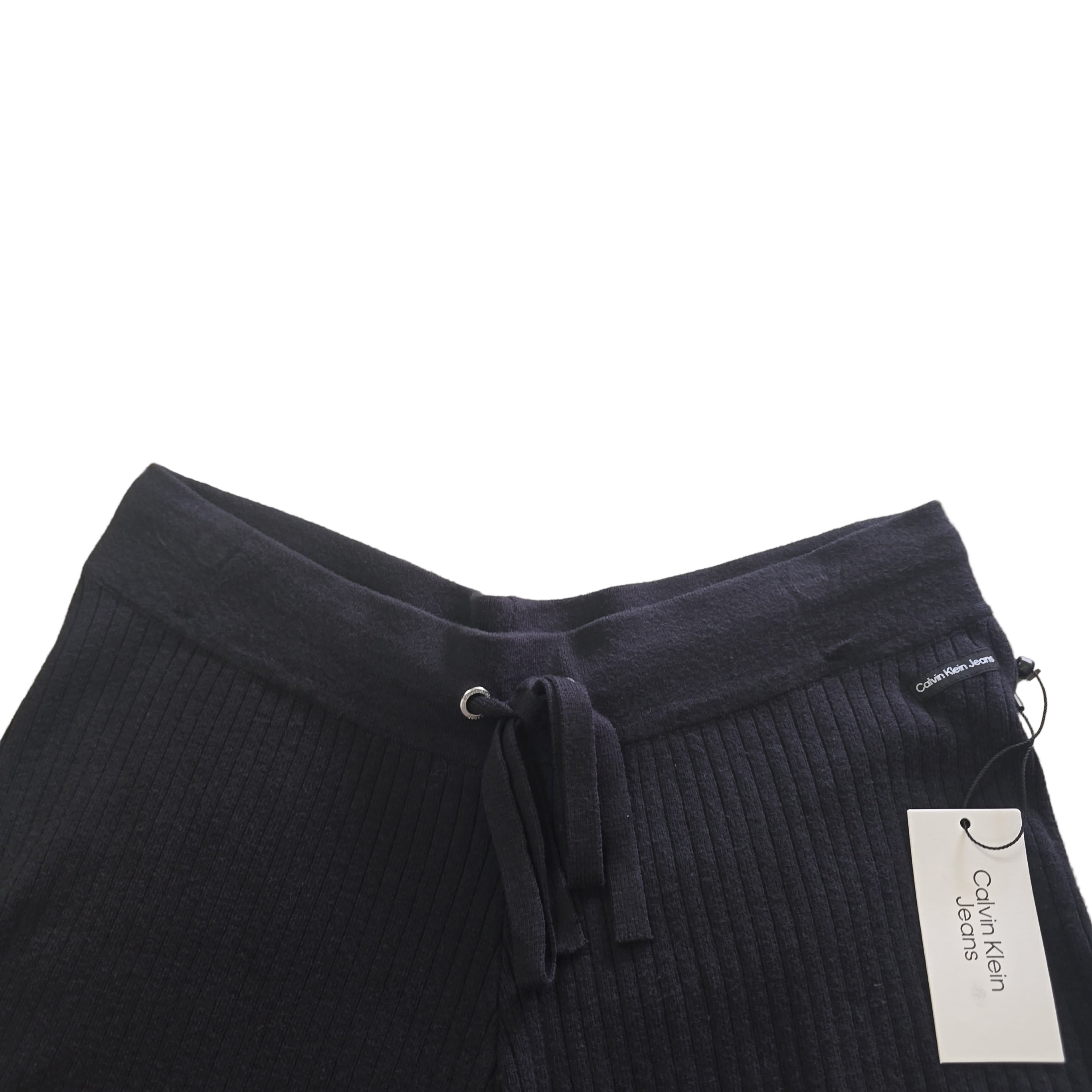 Black cotton shorts with a Calvin Klein label on a light background.