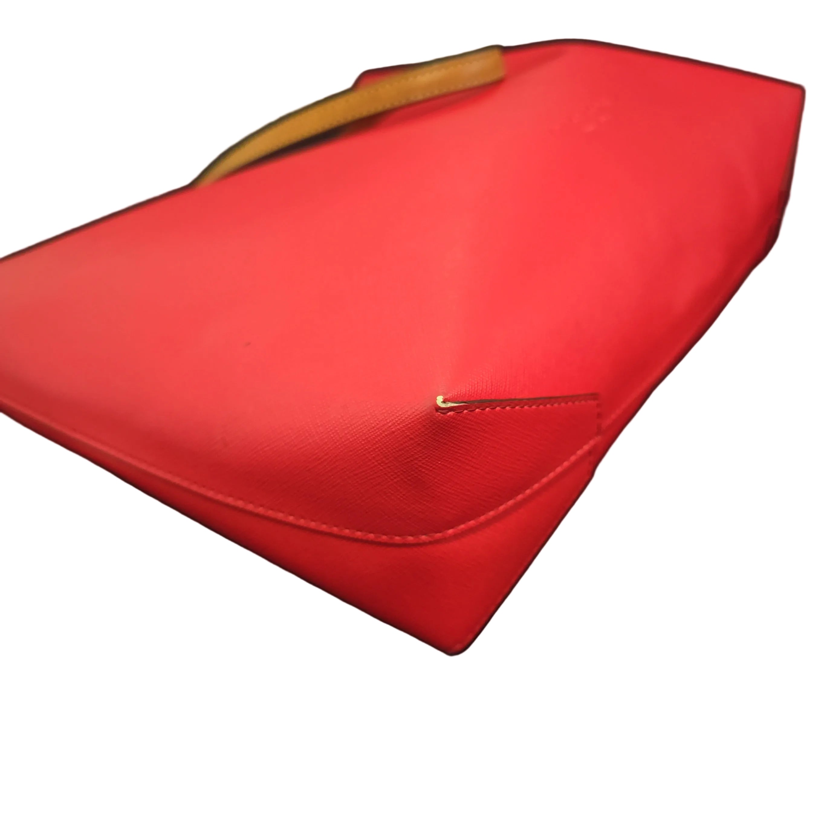 Red handbag with a visible brand logo on a light background