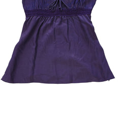 Purple lace-trimmed top on a light background