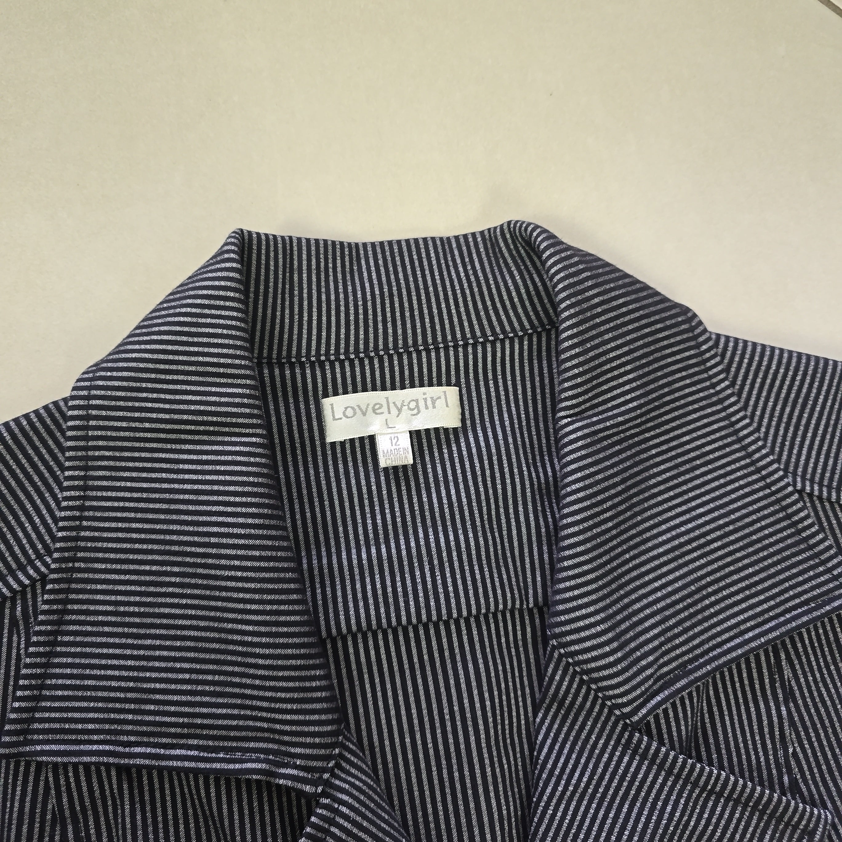 Close-up of a striped garment with a visible label on a beige background