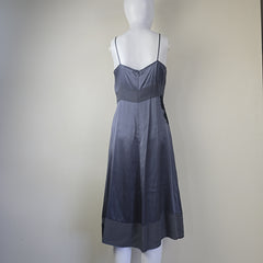 Mannequin wearing a dark gray strapless dress on a plain background