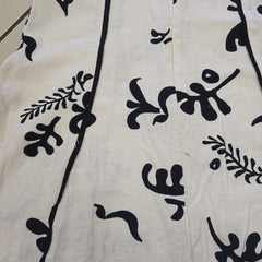 Black floral patterns on a beige fabric background