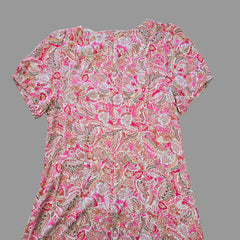 Pink and white patterned dress on a tiled floor