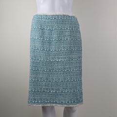 Textured blue skirt on a mannequin arm against a neutral background