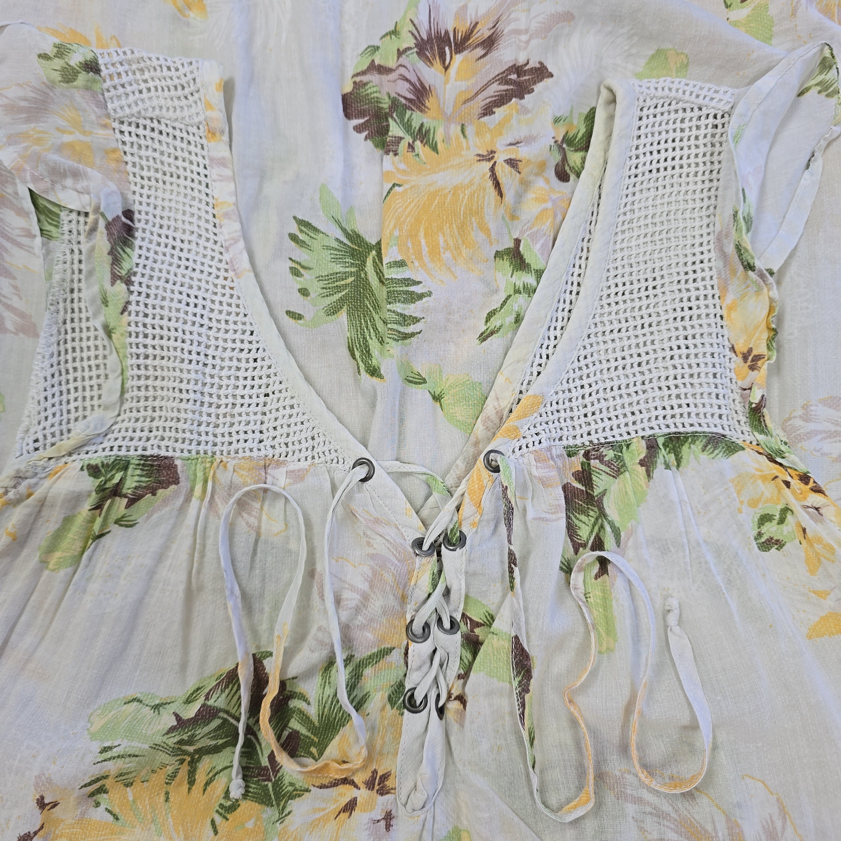 Floral dress with mesh panels on a plain background