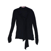 Black top with tie detail on a light background