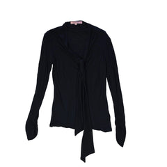 Black top with tie detail on a light background