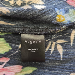 Clothing tag on a floral-patterned fabric with 'Auguste' branding.