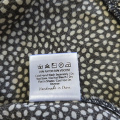 Fabric with a pattern and a label on a piece of clothing.