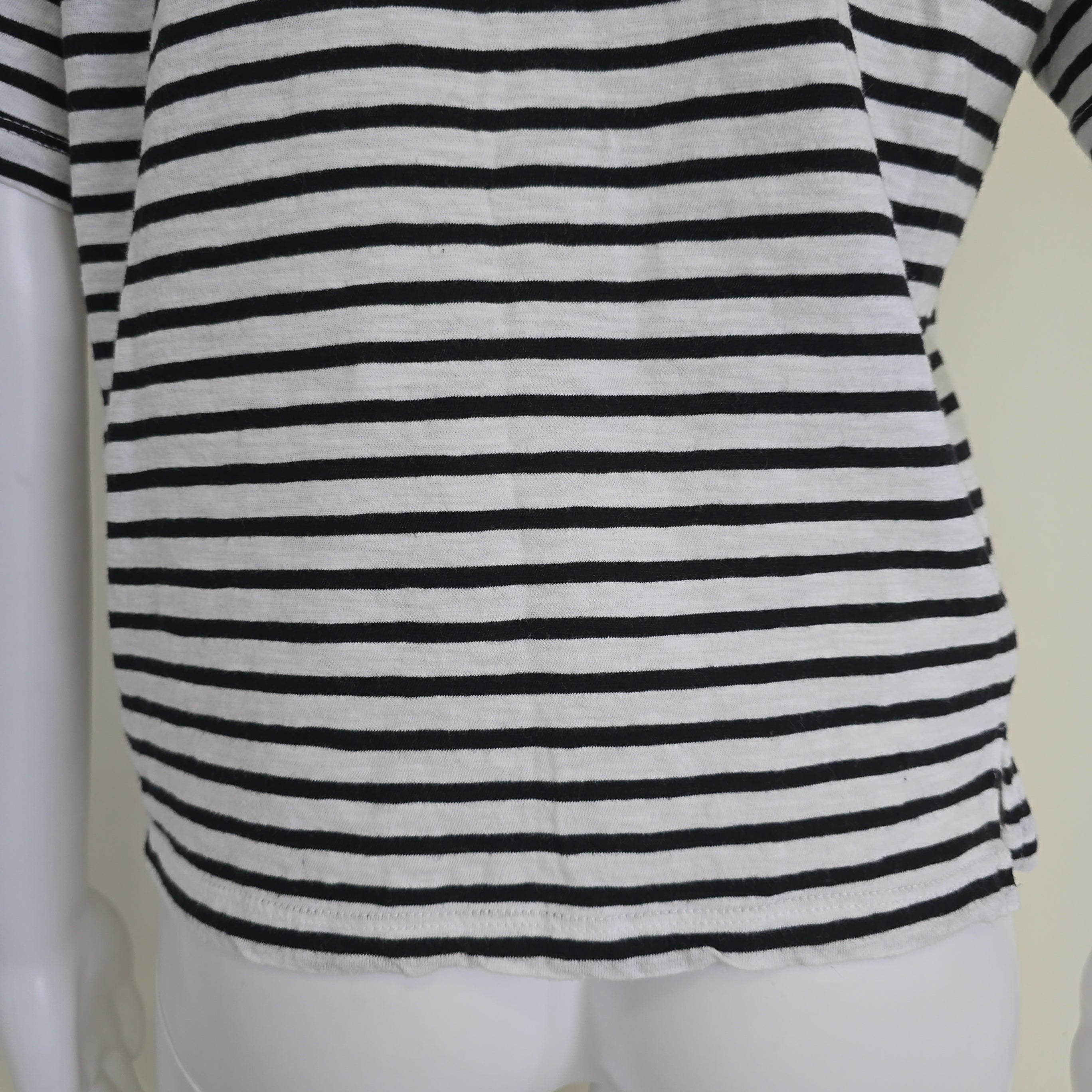 Black and white striped top on a white surface