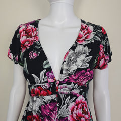Floral patterned garment on a mannequin against a neutral background